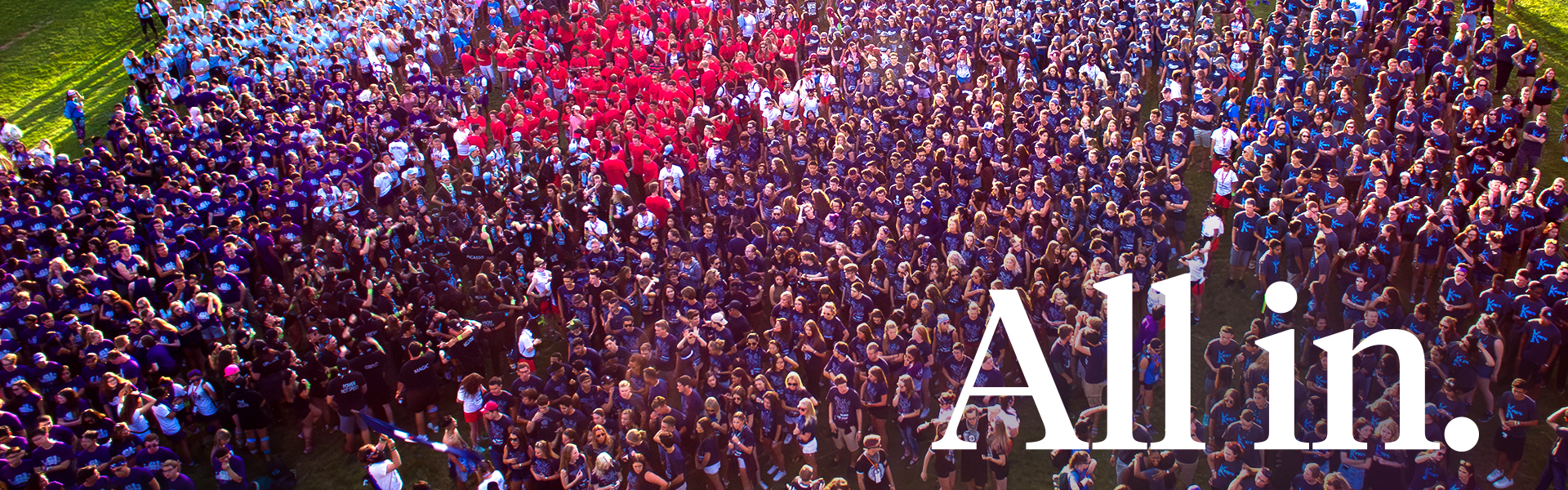 Many students standing together with the text "All in." in the foreground.