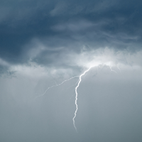 lighting strike on a dark sky coming from a black cloud
